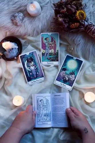 Halloween date night idea with couples doing tarot card readings together, perfect for adding a mystical and fun twist to the spooky season