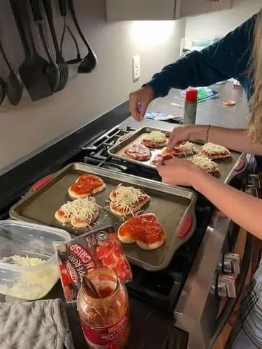 Couple enjoying a Halloween date night by cooking dinner together, perfect for creating a cozy and romantic atmosphere with a fun seasonal twist.