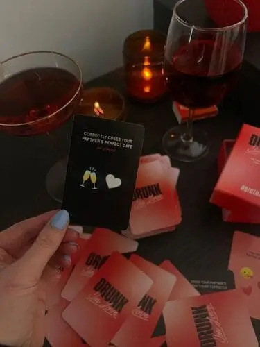 Couple enjoying a Halloween date night playing fun card games together, perfect for an intimate and playful evening with a seasonal twist.