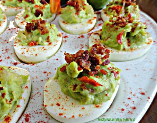 Deviled eggs with wasabi and bacon on a plate