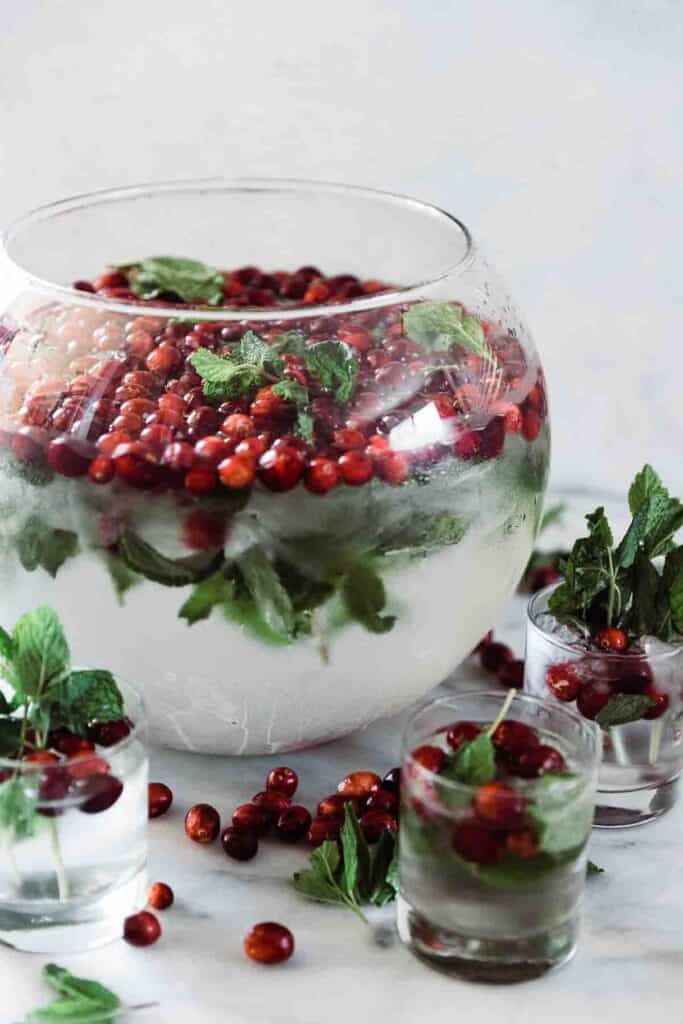cranberry mint water displayed in a punch bowl with glasses set out
