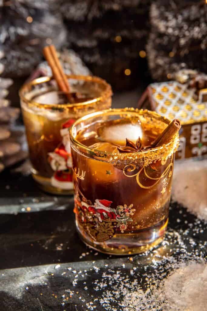 Naughty gingerbread mocktail in a festive glass, garnished with a cinnamon stick