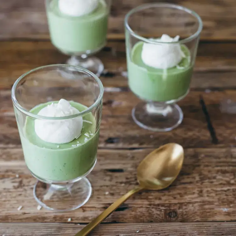 Matcha white chocolate mousse cups with a gold spoon