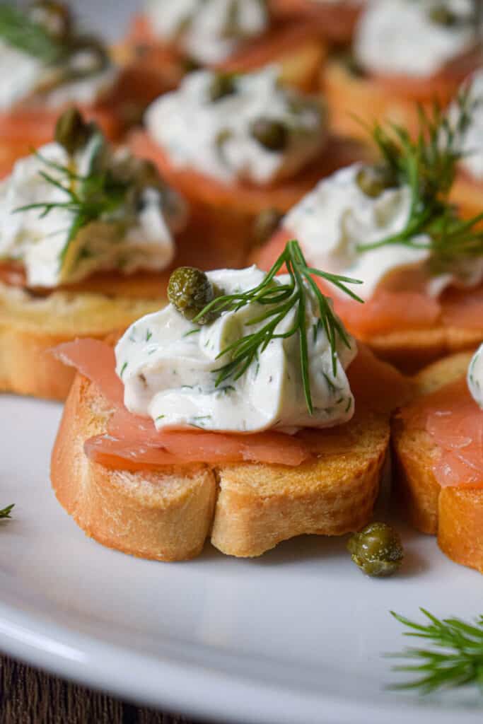 Crostinis with smoked salmon, a dollop of lemon dill cream, sprig of dill and capers