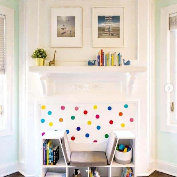 Easily recreate a reading nook in unused space in your home with items readily available for you. Go with a book shelf with sitting area, cute stickable wallpaper polka dots, and some decorative baskets for toys.