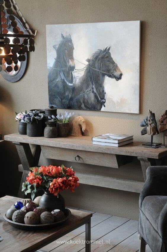 Equestrian wall art displayed in a very tasteful way with console table