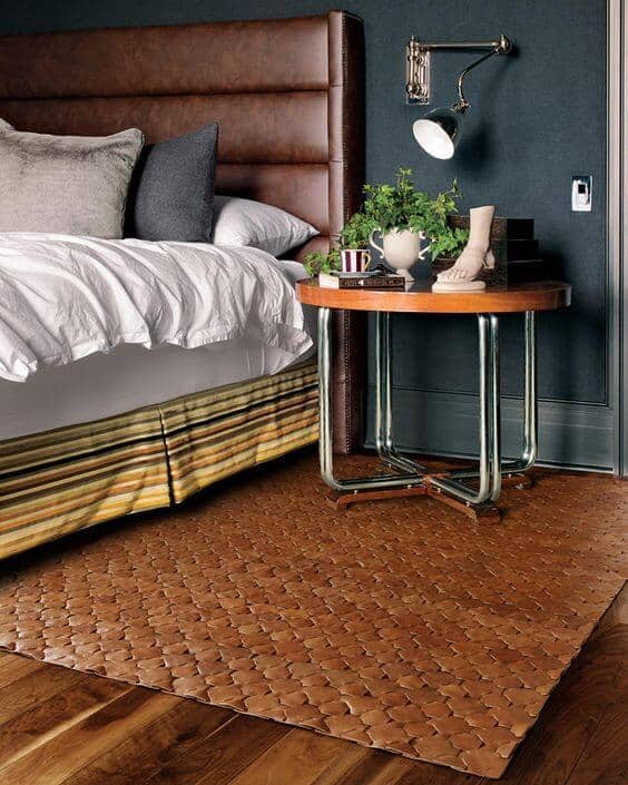 Use leather accents in your room to add a masculine edge. This can also lean into the retro era with the right supporting color palette. Here, you see a leather headboard with a retro bed skirt, retro nightstand and a woven leather area mat. All components compliment each other yet it looks really unique combined.