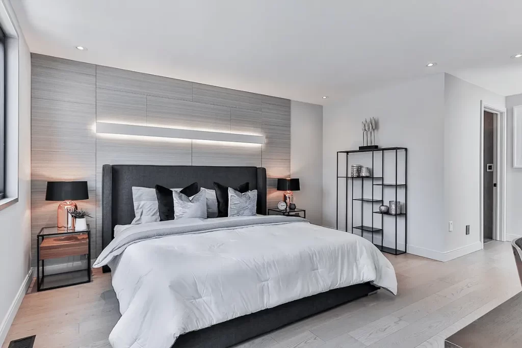 Create a modern bedroom that's contemporary and masculine by using clean lines, modern shapes, and incorporating geometric elements into areas like lighting, rugs, and throw pillows.