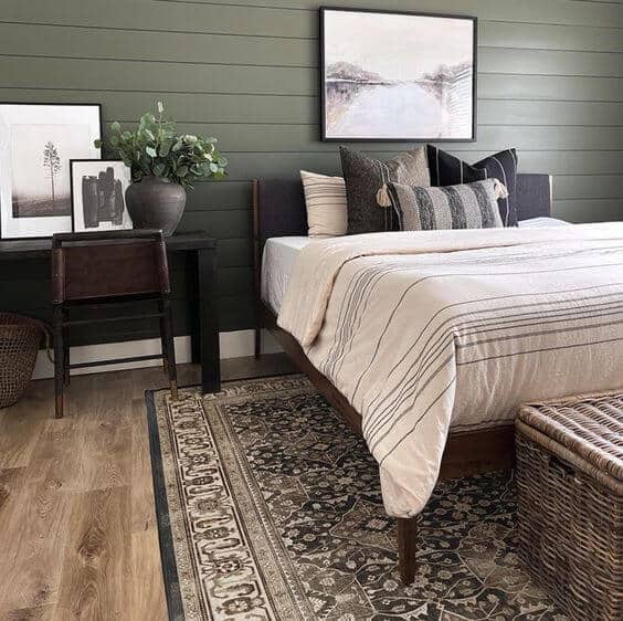 Bedroom with a classic statement rug. Using a larger rug actually makes your room look bigger.