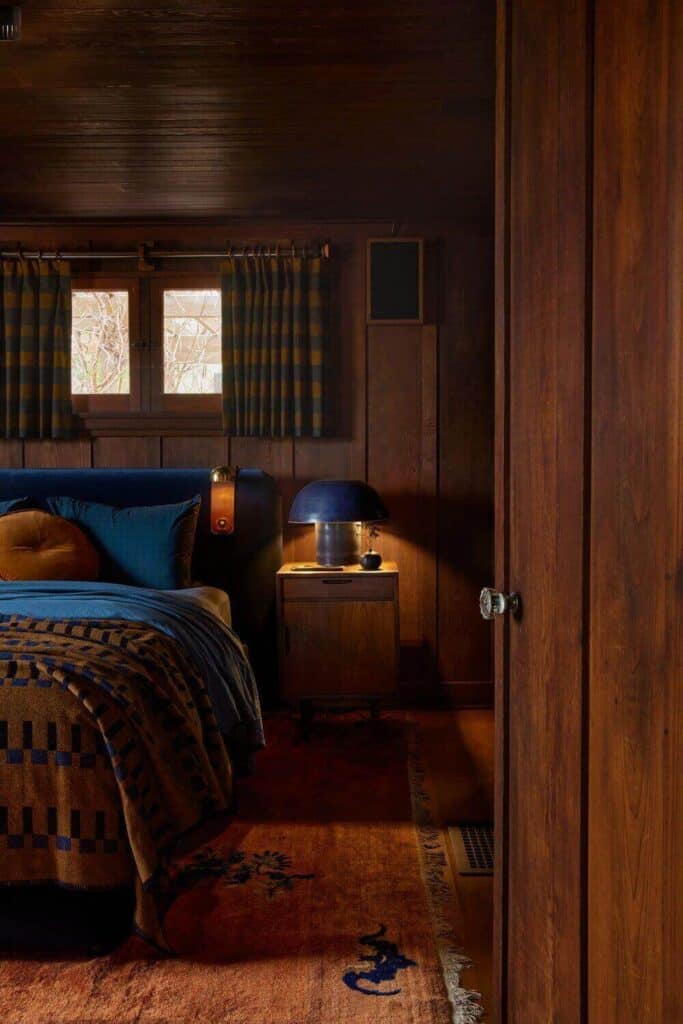 An interesting couples' master bedroom that uses orange, blue, and wood as a color palette.