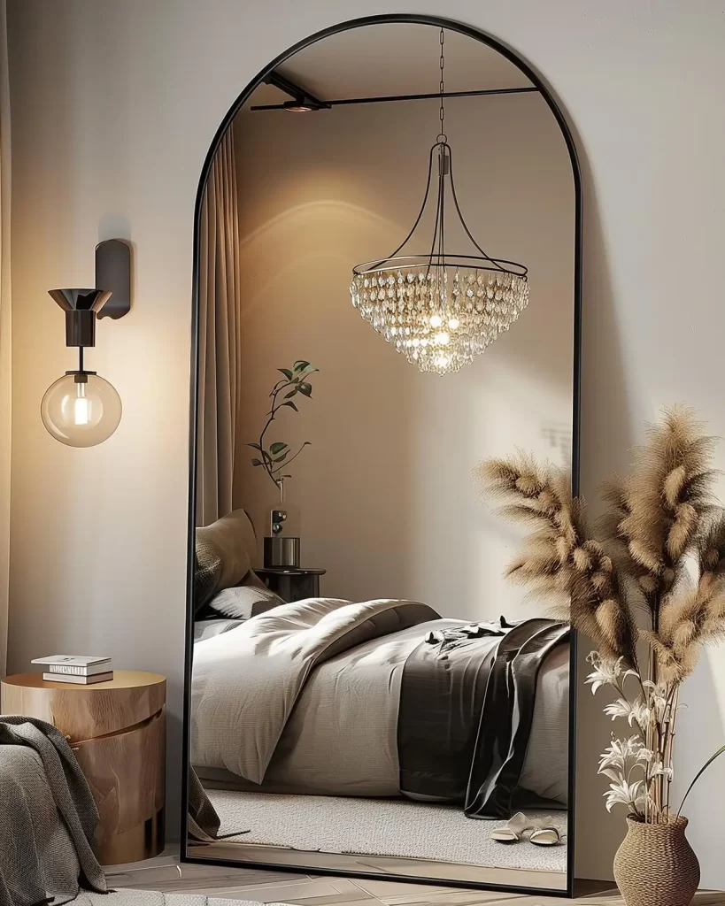 Large black arched mirror to reflect light in women's bedroom