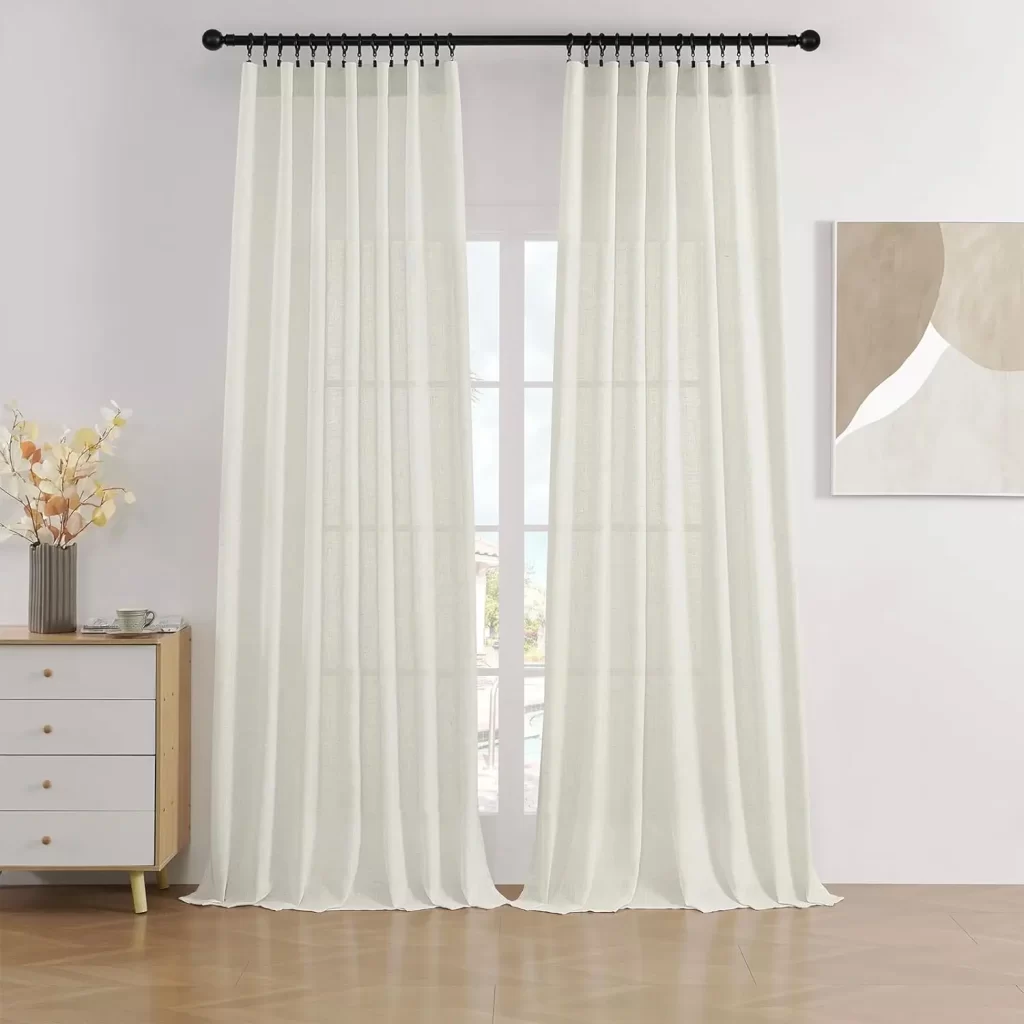 Light filtering curtains give a spacious feel to a long narrow living room dining room