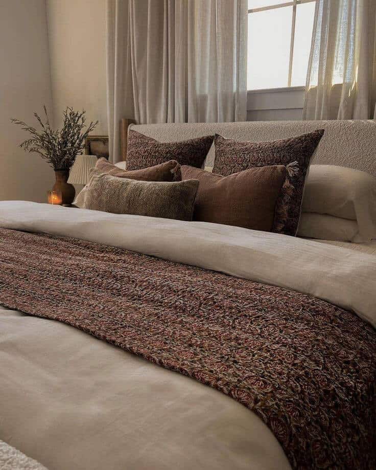 Textured quilt and throw pillows for bed in rich tones that are perfect for a modern organic bedroom scheme