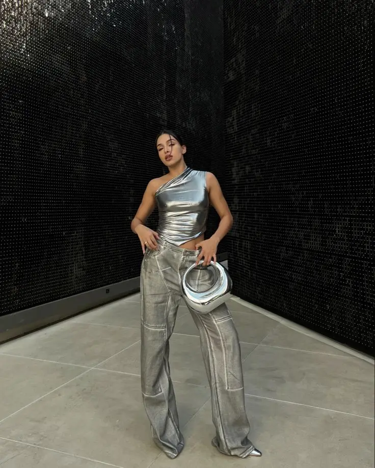 Urban chic silver outfit with silver top, silver handbag, and grey baggy pants