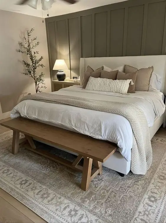 Sage green, neutral shades of cream, and natural wood accents for decorating a woman's bedroom