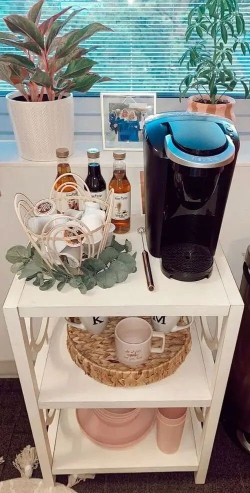 Neatly organized coffee bar in dorm room with Keurig machine, k-cups, syrups, and coffee mugs