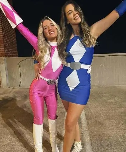 Pink Power Ranger costume featuring a bright pink bodysuit with white diamond accents, a white belt with a silver buckle, and a pink helmet with a white visor, ideal for cosplay and Halloween.