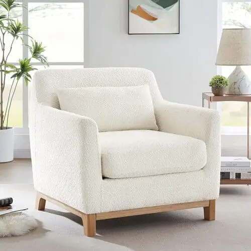 Accent chair in a farmhouse living room, showcasing a stylish design and comfortable upholstery. This piece adds a focal point and enhances the room's farmhouse decor with a touch of rustic charm, perfect for creating a cozy, inviting seating area