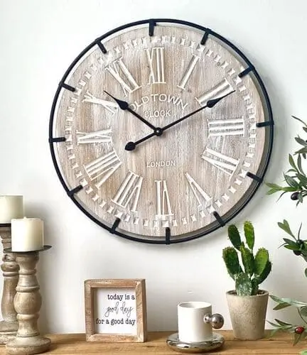 Rustic farmhouse clock available on Amazon, featuring a distressed wood finish and vintage-inspired design. This decorative wall clock is perfect for adding a touch of farmhouse charm to your living room, combining functionality with rustic elegance.