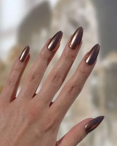 Brushed copper fall nails with a metallic finish, highlighting warm, earthy autumn tones, ideal for a trendy seasonal manicure that captures the essence of fall."