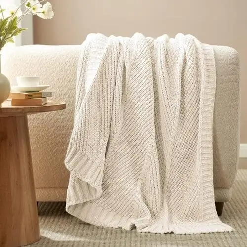 Chenille throw blanket for a cozy farmhouse living room, featuring a soft, plush texture that adds warmth and comfort. This versatile blanket complements rustic and modern farmhouse decor, creating an inviting and stylish space. Available on Amazon for easy purchase.