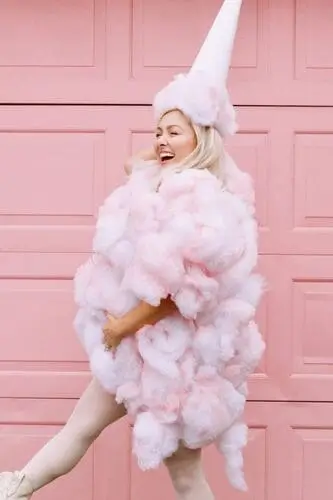 Cotton candy DIY costume made from a T-shirt, pillow filling, and pink fabric spray, creating a fluffy, pastel look that's perfect for a fun and creative Halloween outfit.