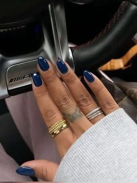 Close-up of dark blue fall nails, featuring a rich, deep hue perfect for a chic and sophisticated autumn manicure, ideal for seasonal nail trends