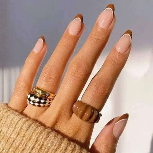 Fall French nails featuring a classic design with autumn-inspired tips in warm hues like deep burgundy, burnt orange, and golden brown, perfect for a seasonal twist on a timeless manicure.