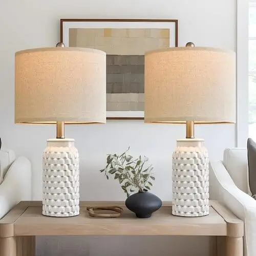 Ceramic farmhouse lamps in a living room, featuring classic designs and neutral tones, adding subtle elegance and warmth to the rustic farmhouse decor.