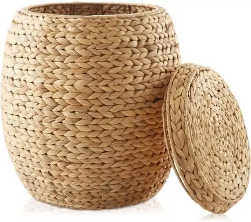 Round storage basket with lid in a farmhouse living room, offering stylish storage and a touch of rustic elegance. This versatile piece complements the natural decor and adds functionality to a cozy, organized spa