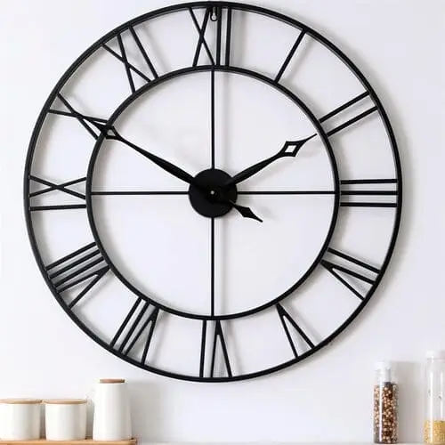 Matte black farmhouse clock with a minimalist design, perfect for adding a modern touch to your rustic decor. This clock combines sleek black metal with farmhouse style, creating a striking focal point for any living room or kitchen.