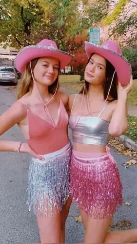 Pink cowgirl costume featuring a bright pink cowboy hat, sparkly top, twirly skirt, and matching boots, perfect for a fun and stylish Western-themed Halloween or dress-up event.