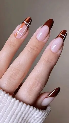 Close-up of plaid nail designs for fall, featuring classic autumn colors like earthy brown, sunflower yellow, cream, and forest green, perfect for a cozy and stylish seasonal manicure.