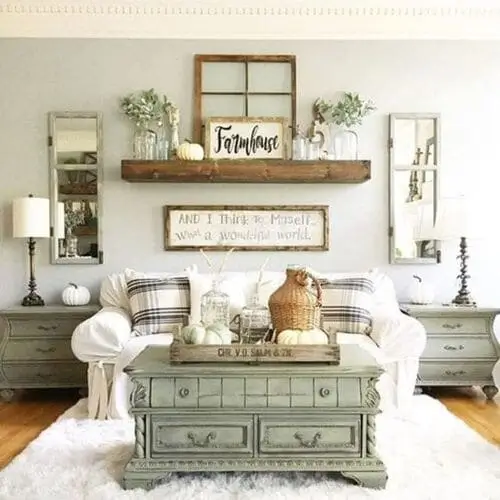 Vintage furniture repurposed in a white farmhouse living room. Features include restored antique side tables, a reclaimed wooden coffee table. The rustic charm blends seamlessly with the white walls and farmhouse decor, showcasing how old furniture can enhance a modern farmhouse aesthetic.