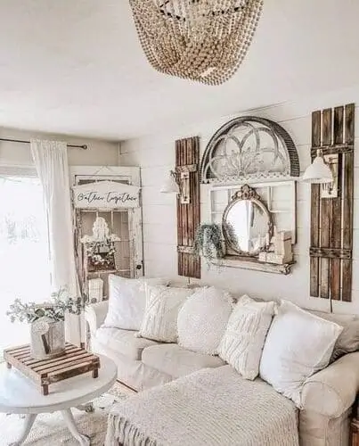 Rustic wood shutter wall decor in a white farmhouse living room, adding vintage charm and character to the space.