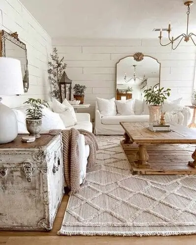 White farmhouse living room featuring wooden furniture, including a rustic coffee table and side tables, adding warmth and natural texture to the space, complementing the modern farmhouse decor.