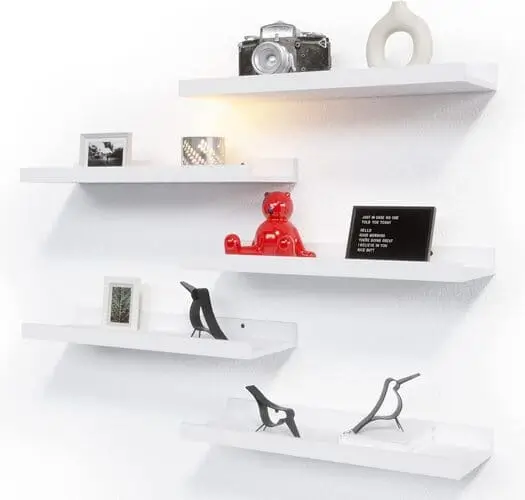 Floating shelves in a studio apartment living room bedroom combo for stylish and functional storage, perfect for organizing books, decor, or plants while saving space