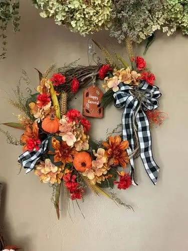 Classic harvest wreath with dried corn husks, wheat, and faux pumpkins, perfect for fall decor. Rustic autumn wreath ideal for front door or home decoration.