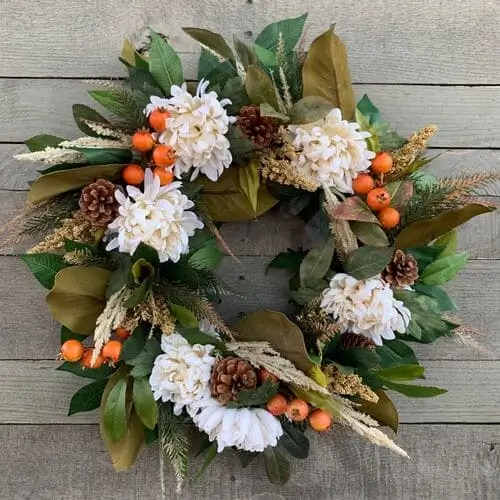 Fall magnolia wreath with lush green leaves and vibrant autumn berries, creating a rich and elegant seasonal decor piece for your front door or home