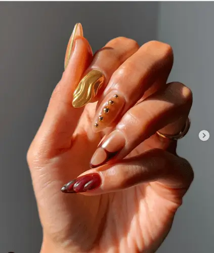 Modern sculpted 3D fall nails featuring gold studded accent nails for a bold, stylish look perfect for the autumn season.