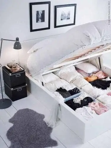 Bed with storage underneath for living room and bedroom combo, maximizing small space functionality. Perfect for studio apartments or multifunctional spaces with hidden storage.