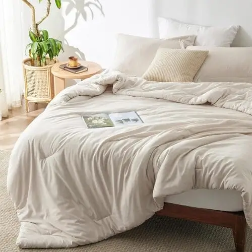 Cozy comforter set in natural colors, perfect for creating a warm and inviting nook in a living room-bedroom combo, enhancing comfort and style.