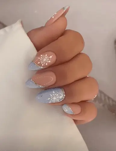 Light blue and silver snowflake nails, winter manicure with icy blue base and sparkling silver accents, perfect for holiday nail art inspiration.