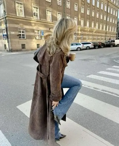 Elegant brown suede trench coat for fall, featuring a soft texture, belted waist, and classic long design. Perfect for a chic and cozy autumn fashion look.