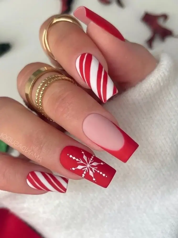 Festive candy cane nails with bold red and white stripes, perfect for a fun and classic Christmas 2024 manicure. Ideal for holiday nail design inspiration.