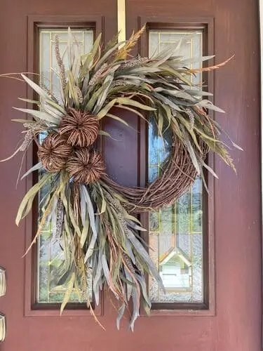 Cascading ornamental grass wreath with lush, flowing grasses and natural accents, perfect for adding a unique and earthy touch to your fall or seasonal decor.