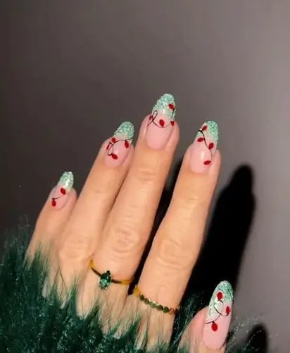 Christmas lights nail design with glittery light green French tips, festive holiday manicure inspiration.