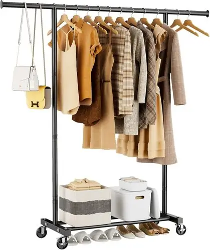 Stylish clothing rack used as a room divider in a studio apartment, creating a distinct living room and bedroom space – explore more functional design ideas at thedecorforum.com!