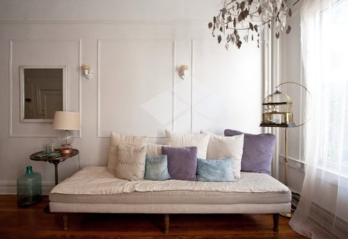 Stylish daybed in a living room-bedroom combo, providing versatile seating and sleeping options while enhancing space efficiency – discover more small space design ideas at thedecorforum.com!