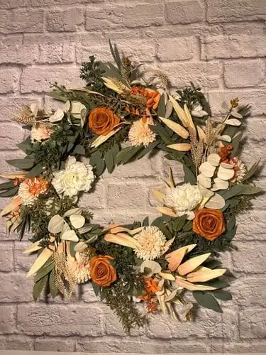 Fall rustic rose wreath with muted roses, dried leaves, and twigs, creating an elegant and cozy autumn decor piece for your front door or home.